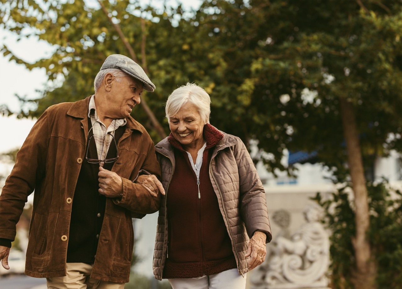 Couple walking through the park in winter. 