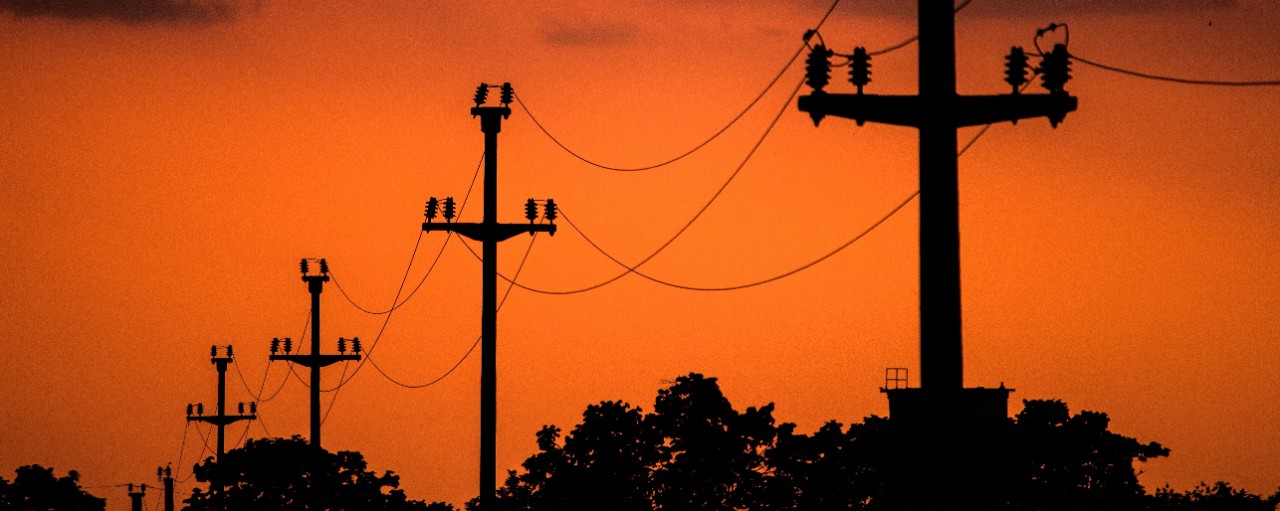 A shot of electric wires connecting with each other during evening time