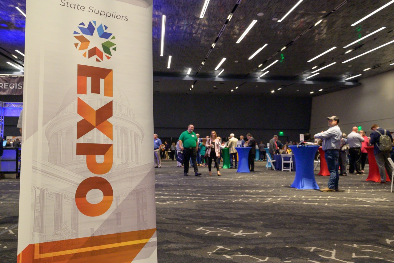 2023 Expo vertical banner with ballroom attendees walking in the background.